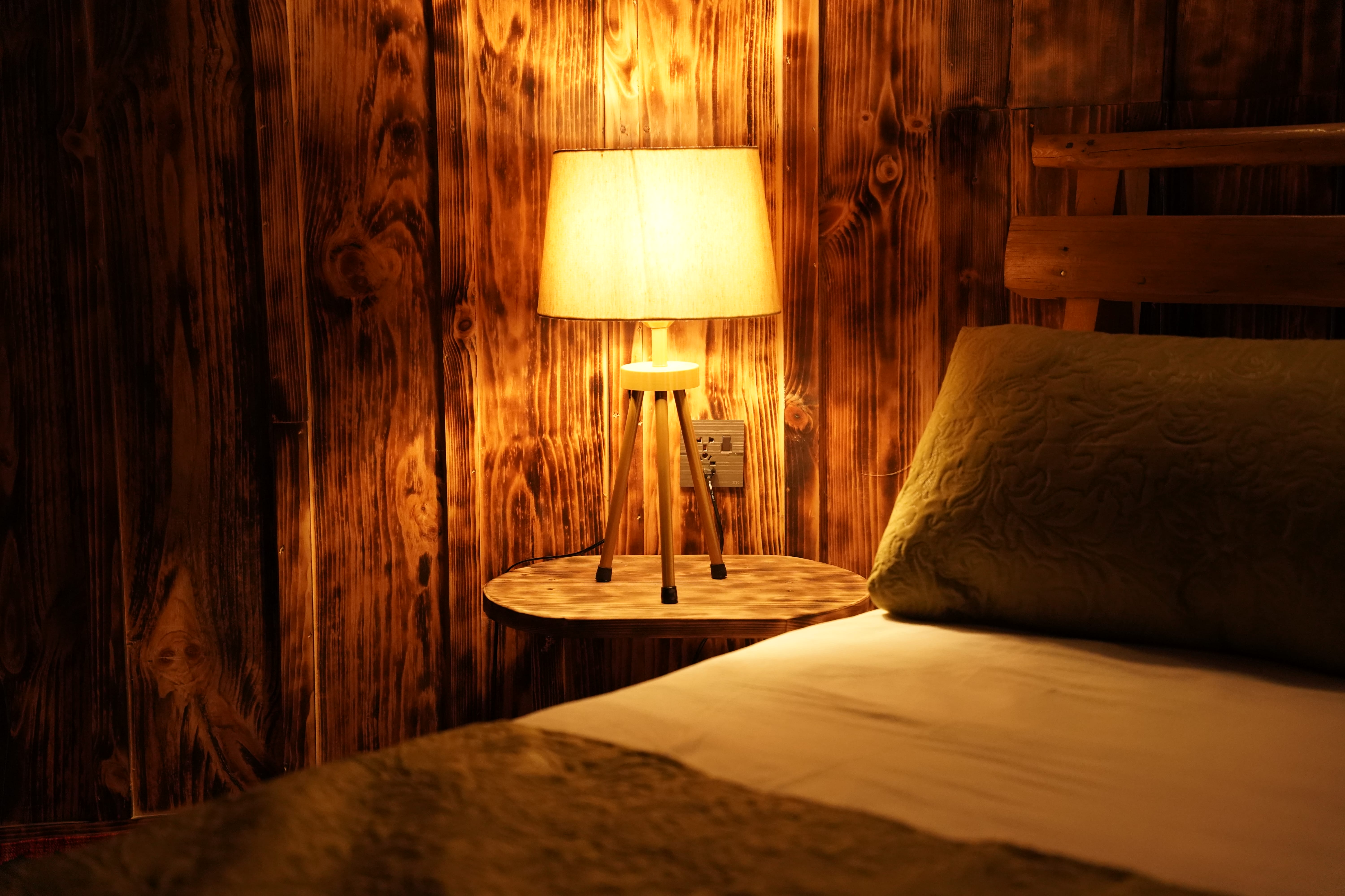 Rustic wooden bedroom with warm lamp lighting